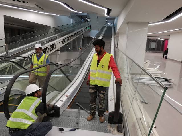 Certified engineering team inspecting an elevator machine room